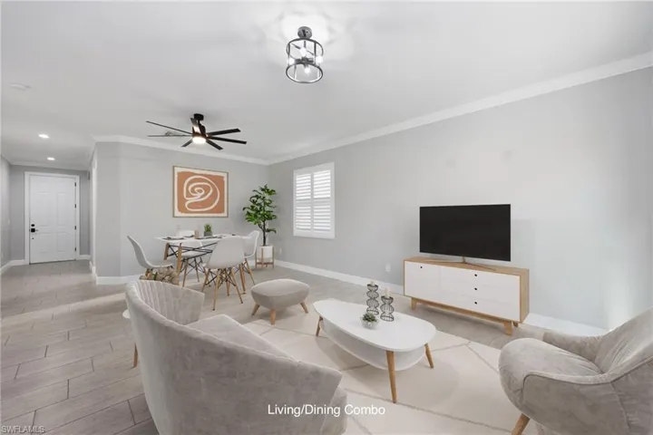 Virtually Staged Living room with ceiling fan, crown molding, and light wood-type flooring