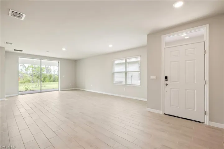 Foyer with light hardwood / wood-style floors