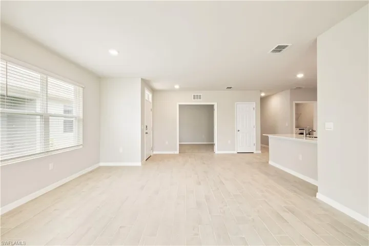 Empty room with sink and light hardwood / wood-style flooring