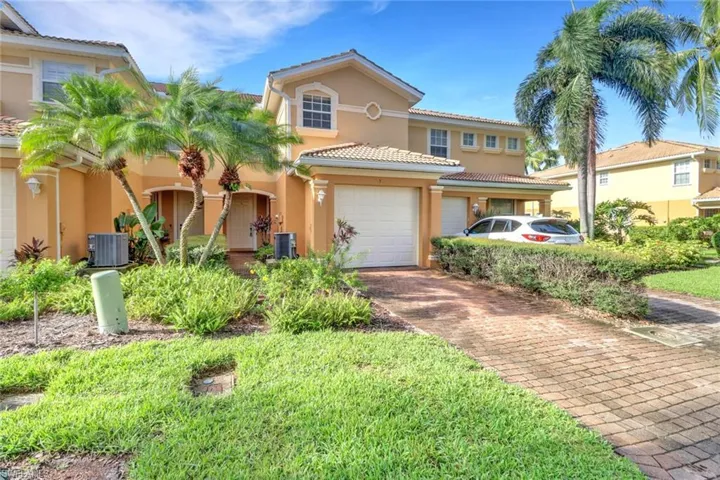 Mediterranean / spanish-style home featuring stucco siding, a tiled roof, and decorative driveway