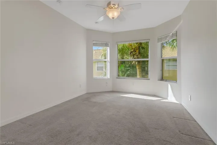 Spare room with carpet and ceiling fan