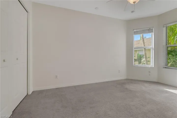 Unfurnished bedroom featuring carpet floors, a closet, and ceiling fan