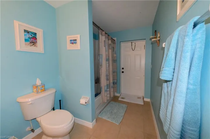 Bathroom with tile flooring and toilet