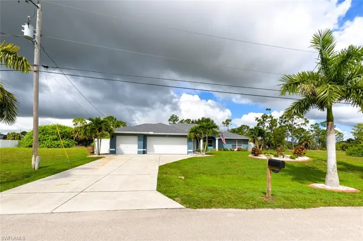 View of front facade featuring 3 car garage and a front lawn