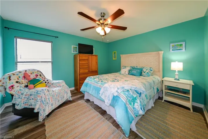 Bedroom with luxury vinyl flooring and ceiling fan