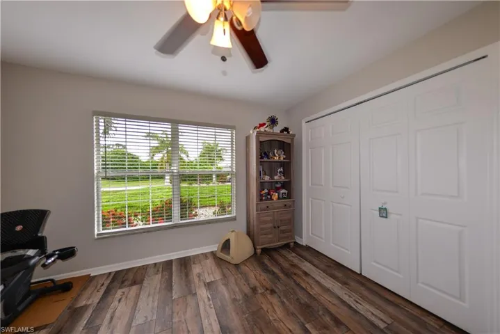 Bedroom featuring a closet, ceiling fan, and luxury vinyl wood-style floors