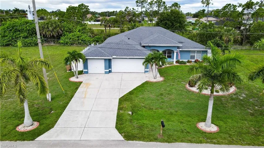 View of front of property featuring a garage and a front yard
