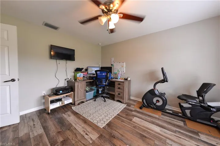 Home office featuring luxury vinyl wood-style flooring and ceiling fan