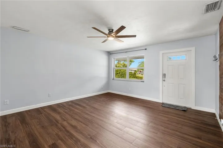 Foyer entrance with ceiling fan and dark hardwood / wood-style floors