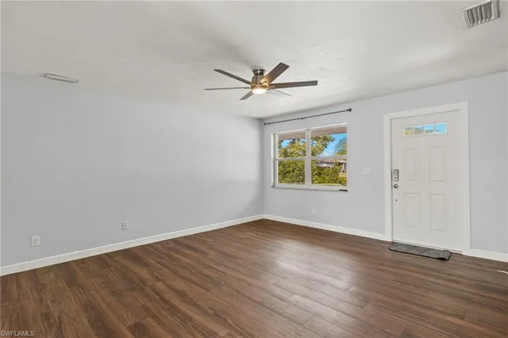Foyer entrance with dark hardwood / wood-style floors and ceiling fan