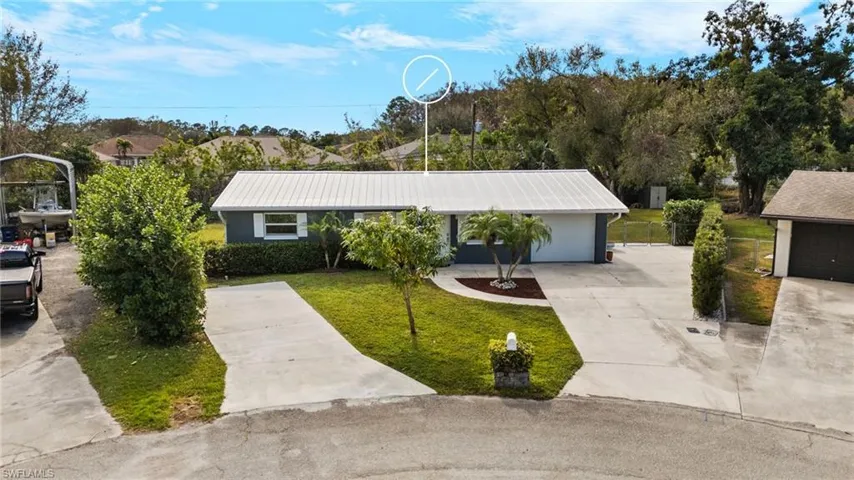 Ranch-style house with a front yard and a garage