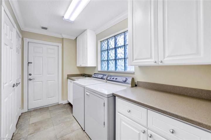 Note the Sink and tons of storage in this sunny Laundry Room