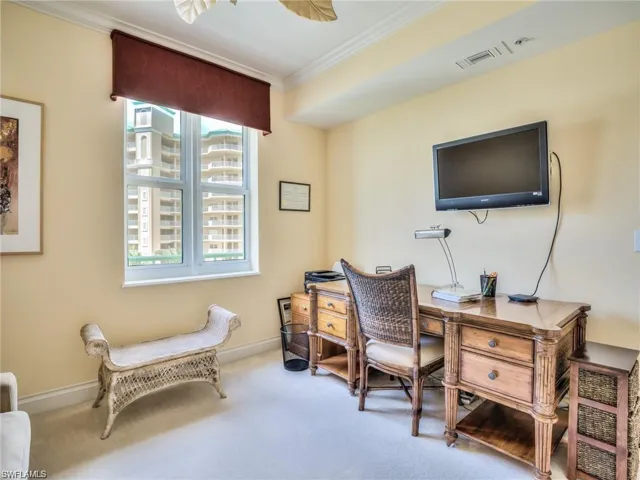 Home office featuring carpet floors and crown molding