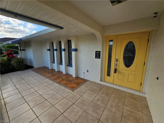 View of exterior entry featuring stucco siding
