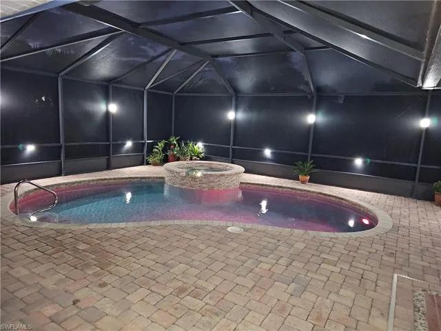 View of swimming pool with a pool with connected hot tub