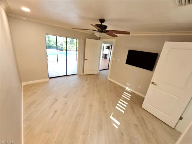 Unfurnished room featuring visible vents, crown molding, light wood-style flooring, and baseboards