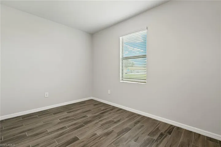 Unfurnished room with dark hardwood / wood-style flooring