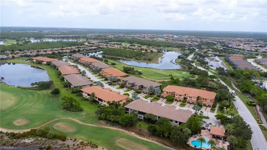 Aerial view of property's location with a large body of water and nearby suburban area