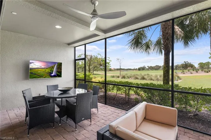 Sunroom with a ceiling fan and outdoor dining area