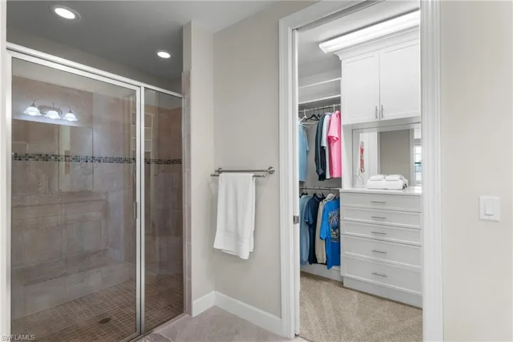 Full bath featuring a stall shower, a walk in closet, recessed lighting, and tile patterned floors