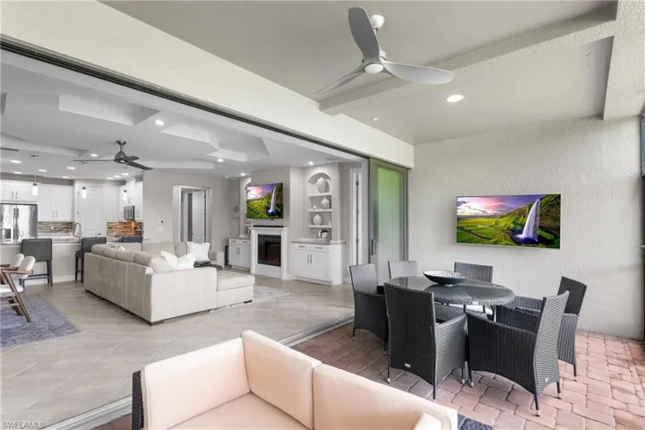Living area featuring ceiling fan, recessed lighting, built in shelves, and beam ceiling