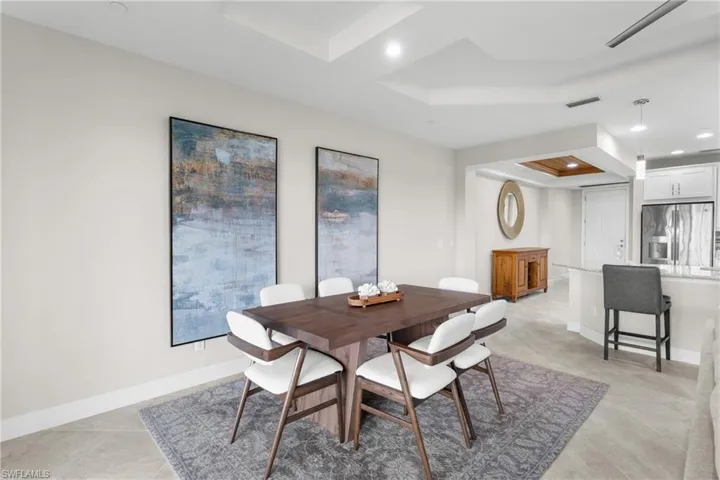 Dining area featuring a raised ceiling and recessed lighting