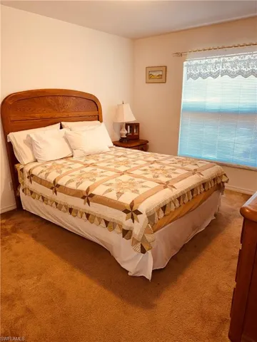 Carpeted bedroom featuring baseboards