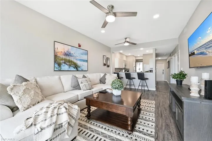 Living room with hardwood / wood-style flooring and ceiling fan
