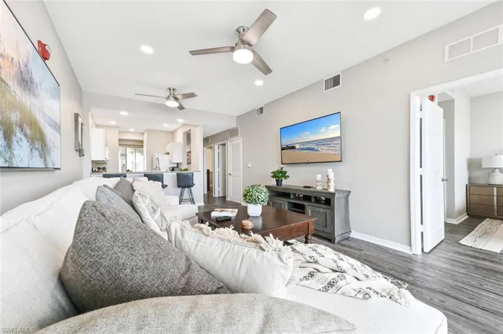 Living room featuring hardwood / wood-style flooring and ceiling fan