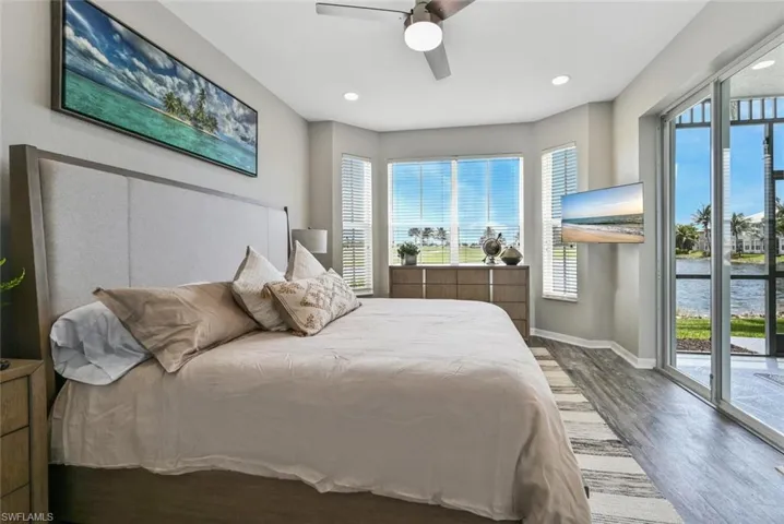 Bedroom featuring hardwood / wood-style floors, access to exterior, and ceiling fan