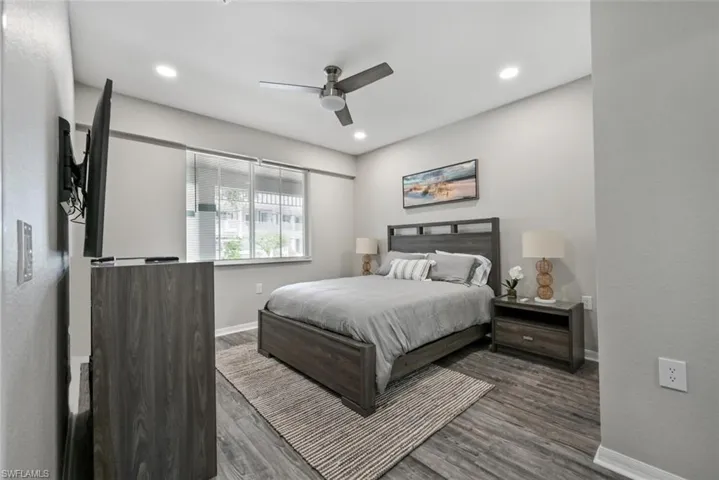 Bedroom with dark wood-type flooring and ceiling fan