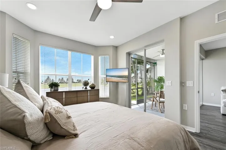 Bedroom featuring multiple windows and access to exterior