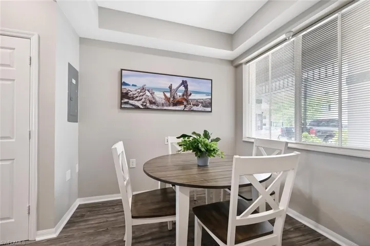 Dining space featuring electric panel and dark hardwood / wood-style floors