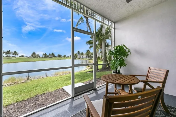 Sunroom / solarium featuring a water view