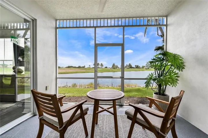 Sunroom / solarium featuring a water view and a wealth of natural light