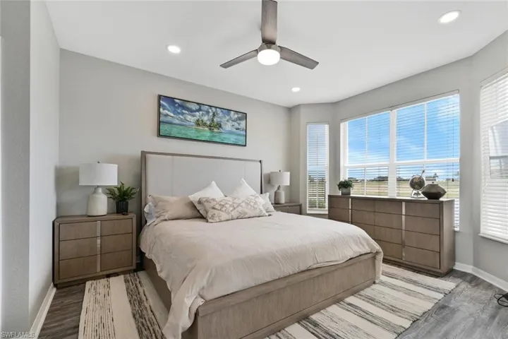 Bedroom featuring ceiling fan and light hardwood / wood-style flooring