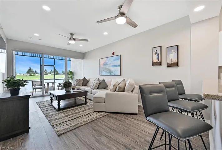 Living room featuring hardwood / wood-style floors and ceiling fan