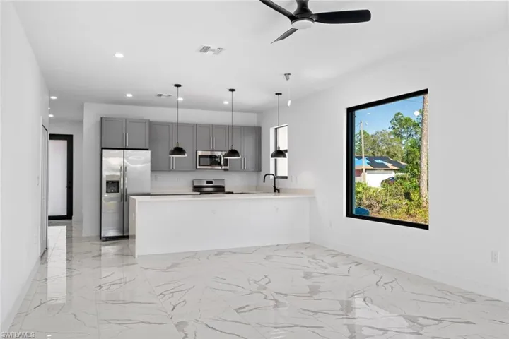 Kitchen with baseboards, appliances with stainless steel finishes, visible vents, and light countertops