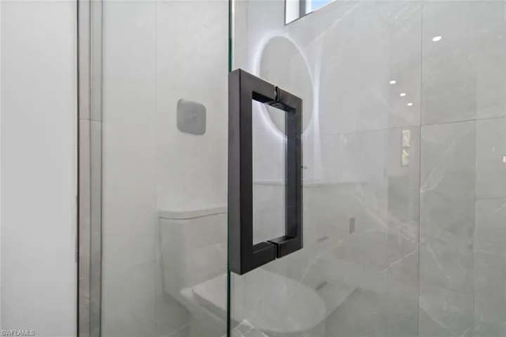 Full bathroom featuring a shower stall