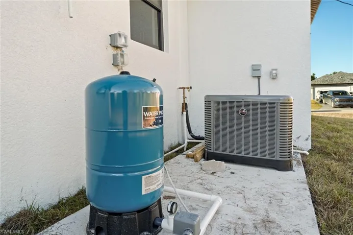Details with central air condition unit and stucco siding