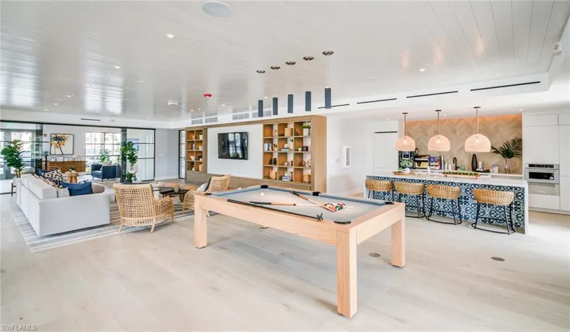 Recreation room featuring light wood-style flooring, wooden ceiling, and pool table