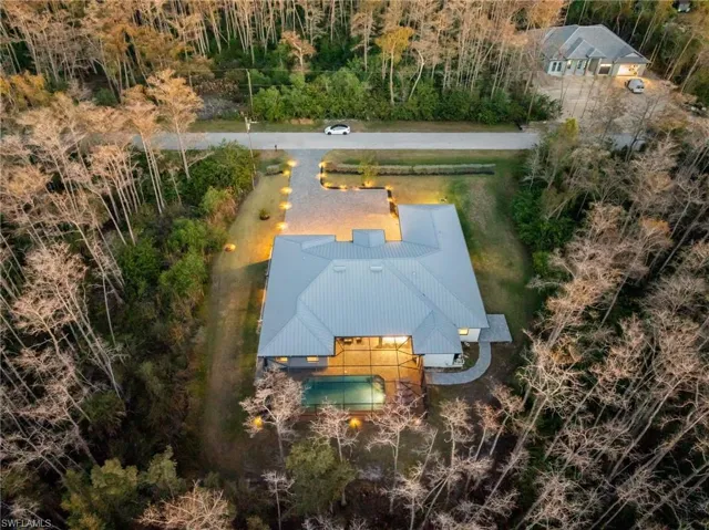 Built like a fortress, this home features solid concrete block construction, a metal roof, and hurricane-impact windows and doors throughout, including brand-new modern French entry doors with impact glass inserts.