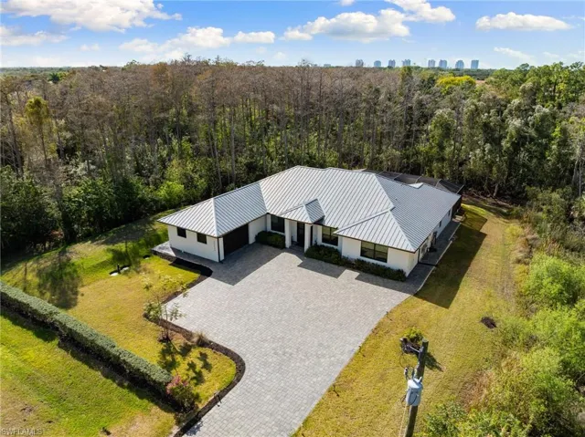 CUSTOM-BUILT 2021 NEW CONSTRUCTION POOL HOME ON A BEAUTIFULLY WOODED AND EXCEPTIONALLY PRIVATE 1.25-ACRE LOT IN BONITA SPRINGS’ HIGHLY COVETED “SAN CARLOS ESTATES!”
