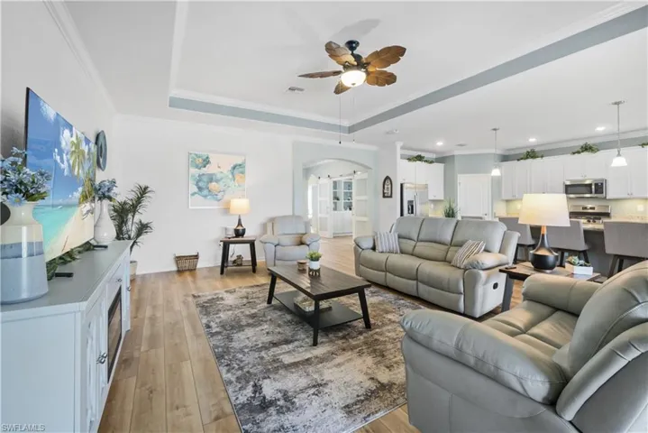 Living area w/LVP flooring. Fan, tray ceiling
