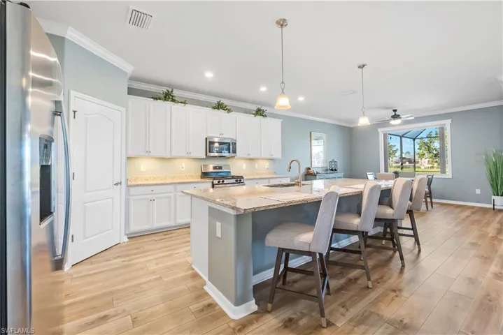 Kitchen w/ stainless steel appliances, walk-in pantry LVP floors