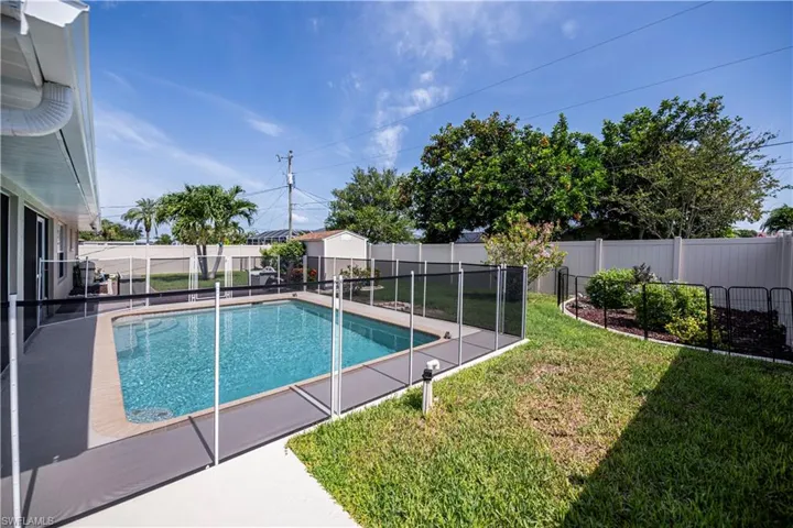 View of pool featuring a safety fence