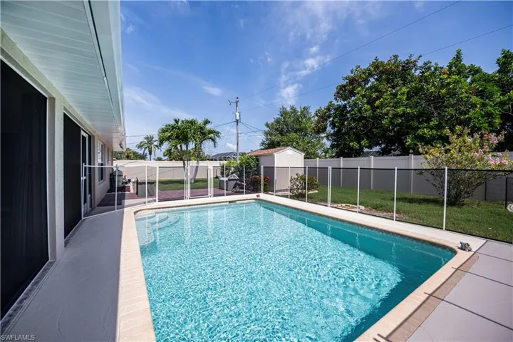 View of swimming pool with a safety fence surrounding the pool