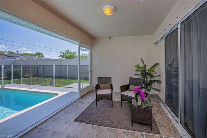 View of pool featuring a patio and screen enclosure