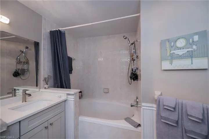 Bathroom featuring shower / tub combo and vanity