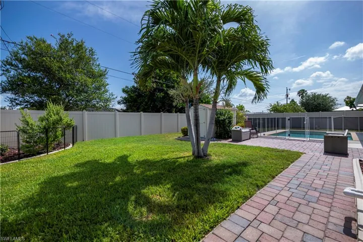 View of yard with a fenced in pool and a patio